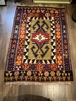 Full top-view of hand knotted kilim rug showing overall geometric pattern and colors