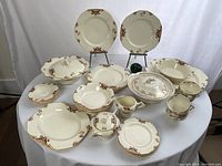 Full set of Marigold Balmoral and Golden Astoria pieces arranged on table