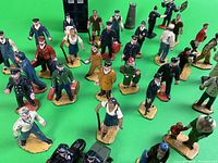 Group view of painted lead figures on green background