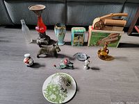 Photo shows all items including the Miracle Broom box, Orange Crush bottle, Western Germany vase, and various figurines.