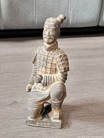 Front view showing detailed armor and face of terracotta soldier statue