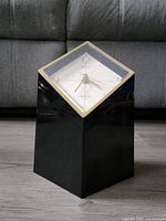 Full view of the Yamanaka Japan desk clock showing its black geometric base and diamond-shaped clock face with gold trim.