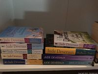 Stack of Jude Deveraux novels showing titles with visible spines on bookshelves.