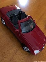 Red Mercedes convertible die cast metal model car, black interior, silver rims.