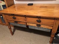 Full front view of antique wooden flour bin showing four drawers with metal liners and two fold-down boards on top sides.