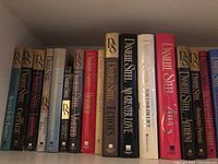 Shelf of 15 Danielle Steel hardcover novels showing titles and varied dust jackets with "DS" logo.
