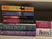 Photo showing six Diana Palmer novels and spines of Maeve Binchy and Belva Plain books.