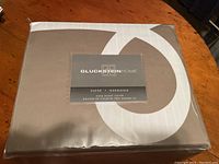 Front view of the Gluckstein Home duvet cover packaging showing brand and collection details.