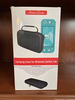 Front of packaging showing the product name and image of the black carrying case along with a Nintendo Switch Lite handheld console.