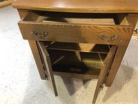 Front view of the washstand showing the drawer open and cabinet doors open revealing storage space and single shelf inside.
