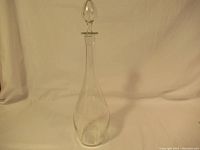 Full view of the vintage glass decanter showing its slender body and long neck.