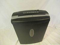Front view of black OmniTech paper shredder showing paper entry slot and clear window to view shredded contents.