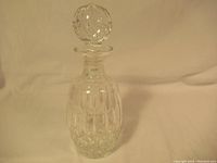 Full view of the Waterford crystal decanter showing the cut pattern on the body and attached stopper.