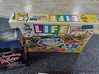 The Game of Life Simpson's Edition box showing colorful cartoon graphics themed around the Simpsons.