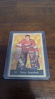 Front of 1961-62 Parkhurst Terry Sawchuk hockey card showing image of Sawchuk in goalie gear, Detroit Red Wings jersey number 31.