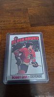 Front side of the 1976-77 Topps Bobby Orr hockey card showing Bobby Orr in Chicago Black Hawks uniform.