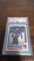 Photo of 1986-87 Topps John Vanbiesbrouck rookie card graded PSA 8 in protective slab.