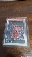 Front side of 1988-89 Fleer Scottie Pippen rookie basketball card in protective sleeve showing Pippen in red Chicago Bulls jersey number 33 mid-action on court.