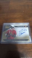 Front of Jared Cowen rookie autograph card showing player in Ottawa Senators uniform and autograph