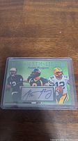 Front of Aaron Rodgers Man Myth Legend card with three images and a facsimile autograph.