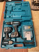 Photo showing complete Makita cordless power tool set inside blue plastic molded case.