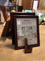 Set of framed pictures with a prominent Michaels Home Collection 16 x 20 inch dark wood frame