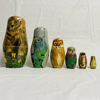 Front view showing six animal-themed nesting dolls in a lineup
