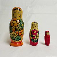 Front view of three Babushka nesting dolls showing colorful floral hand-painted designs.