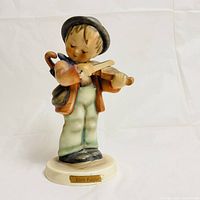 Front view of the Goebel Hummel Little Fiddler figurine showing the boy playing violin.