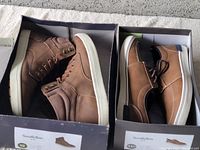 Pair of brown high-top casual shoes and pair of low-top sneakers in boxes