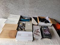 Lot shows multiple shoeboxes with various women's shoes inside or visible. Boxes display brands including Calvin Klein, Joseph Abboud, and Timothy Hitsman.