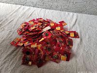 Pile of Raiders football team trading pins in original red card packaging with yellow Sears pricing stickers.