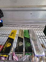 Three Jurassic Park The Lost World Techno Time watch boxes on metal shelf, side view showing logos and colors