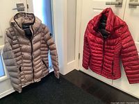 Front view of both jackets showing color and design details such as zippers and hood