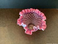 Top view of cranberry hobnail glass bowl showing ruffled edge and hobnail texture on inside and outside surfaces.