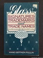 Front cover of the book showing title, author's name, and geometric designs on a teal-blue background.