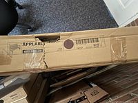 Photo showing the cardboard packaging with the IKEA Applaro model label 802.085.29 for the garden bench.