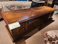 Rectangular coffee table top and side view showing wood grain and panel design.