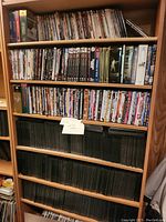 Wide view of shelves densely packed with assorted DVDs and boxed sets.