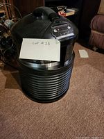 Front angled view of Filter Queen air purifier showing handle and control panel.