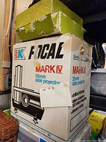 Box for Focal Mark IV 35mm slide projector showing brand and model with wear on box.
