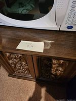 Top view showing wood grain surface and label 'Lot #4' next to microwave.