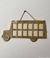 Front view of brass school bus picture frame with 10 photo slots and school year labels