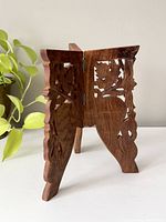 Front and angled side view showing floral cutout design and folding hinge.