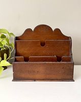 Front view of vintage tall wooden office stationery organizer showing three tiers and scalloped top design.