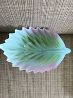 Leaf shaped centerpiece bowl photographed on fabric surface, showing colors and texture