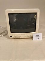 Front view of Panasonic 11-inch color CRT TV, showing screen, front panel controls, and speaker grill in cream plastic casing.
