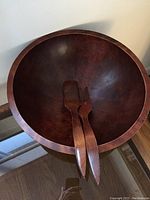Photo of large solid maple salad bowl with serving fork and spoon inside, showing the size and finish.