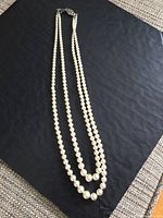 Double strand pearl necklace laid flat showing length and pearl quality.