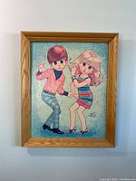 Frontal view of the framed vintage 60s LEE Big Eye go go dancers illustration with wooden frame
